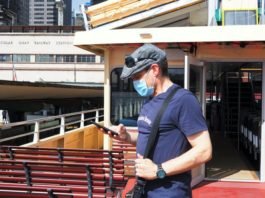 Man wearing mask while using phone | Imager: Shutterstock