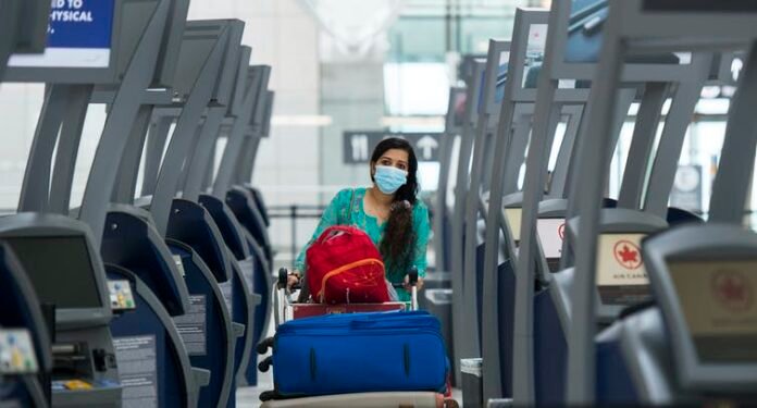 A traveller walks between empty check-in kiosks THE CANADIAN PRESS:Nathan Denette A traveller walks between empty check-in kiosks at Toronto’s Pearson International Airport in June 2020. THE CANADIAN PRESS/Nathan Denette