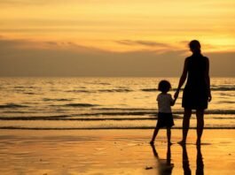 Mother and child at sunset on the beach | Photo: Shutterstock