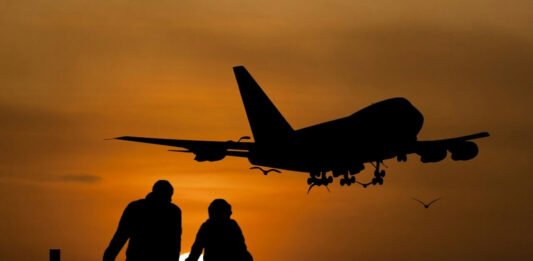 Silhouette airplane travellers sunset
