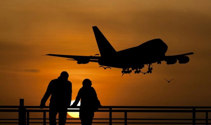 Silhouette airplane travellers sunset