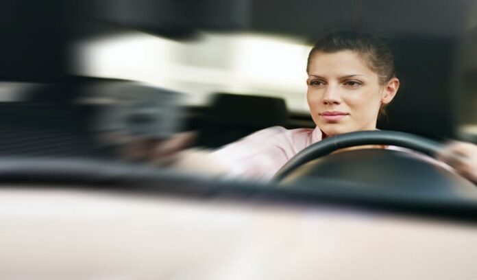 Woman driving | Diego Cervo/Shutterstock