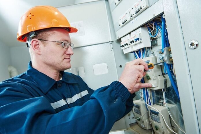 electrician with screwdriver repair or fixing high voltage switching electric actuator in fuse box